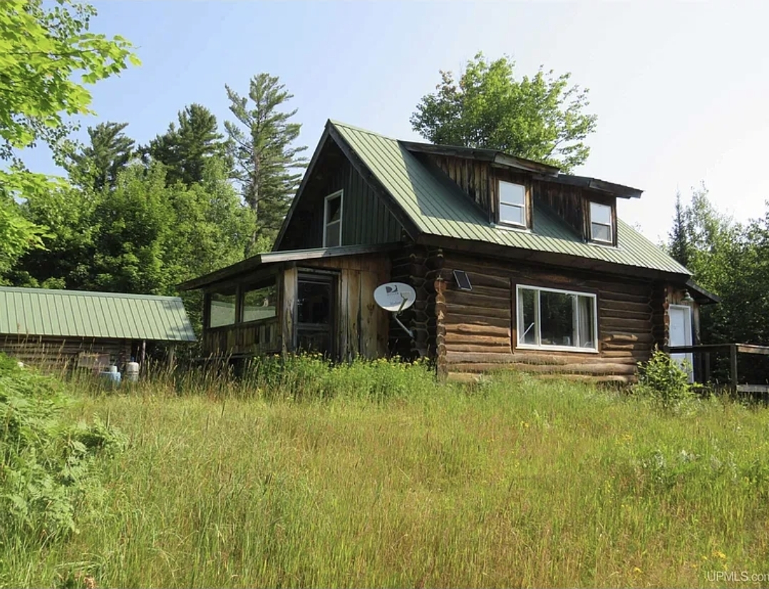 40-Acre Off-Grid Log Cabin with Sauna, Wood Stoves, and a Spacious Bunkhouse Loft