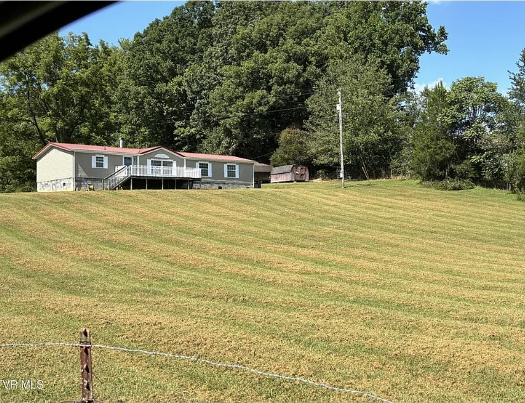 3-Bedroom Manufactured Home with a Permanent Foundation, Fireplace, and Two Outbuildings